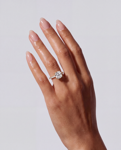 Noémie – Cushion Verlobungsring mit Hidden Halo & Pavé in Gelbgold, getragen an der Hand | Élysée Diamonds